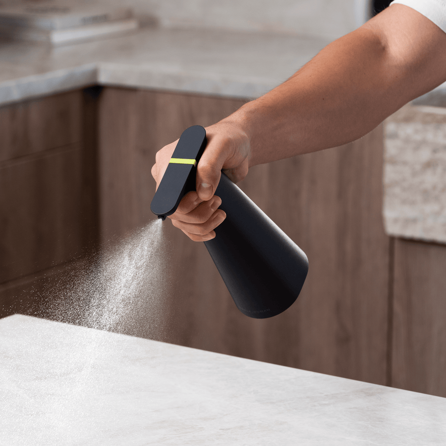 Simplehuman Matte Black Sensor Spray used handheld, showing automatic misting action.